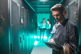 Man with Beats headphones playing Angry Birds